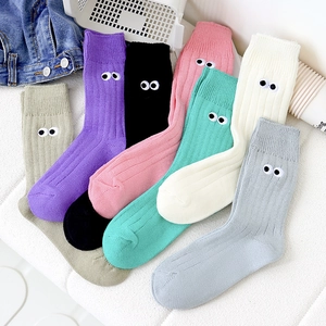 Detailed embroidery of cartoon eyes on colorful knitted cotton slouch socks for women