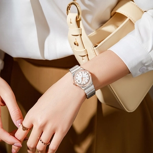 Elegant two-tone steel watch for women with diamond bezel and white wavy dial