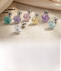 Close-up of hexagonal zircon titanium steel stud earrings in seven vibrant colors