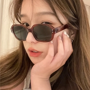Retro oval tortoise shell sunglasses for women with vintage studs and dark lenses