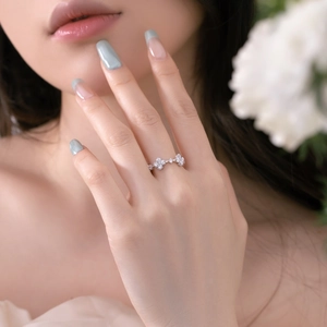 Close-up of S925 sterling silver flower ring with zircon stones on a female hand