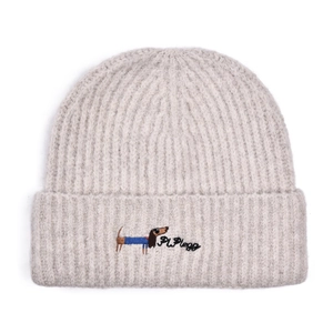 Close-up of ribbed knit beanie with blue dachshund embroidery and Pi Plege lettering
