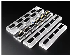 Macro shot of 4-piece clear acrylic ring display stand with black foam slots