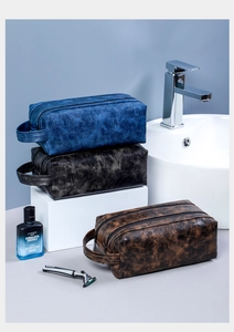Detail of PU leather toiletry bags in blue, black, and brown with a vintage texture