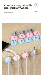 Detail of round cable organizer buckles with adhesive backing on a desk surface