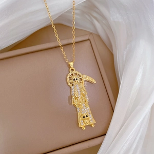 Luxurious gold Santa Muerte pendant necklace with sparkling cubic zirconia on beige leather box