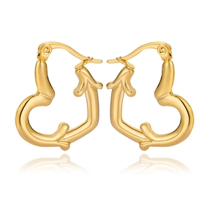 Detailed close-up of gold heart-shaped hoop earrings with a textured bamboo style finish