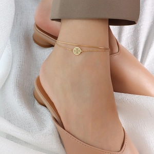 Elegant 18k gold double-layered titanium steel anklet worn with stylish beige shoes
