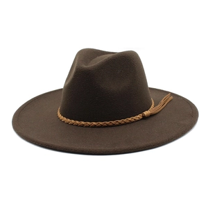 Detailed view of dark brown wool fedora hat featuring a light leather braided belt and tassel
