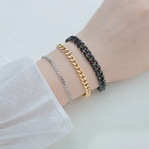 Three-piece Cuban link bracelet set in silver, gold, and matte black stainless steel
