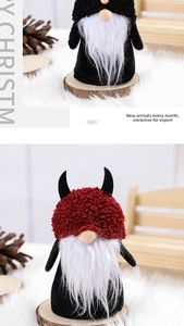 Detail of plush Halloween gnomes with black fabric and devil horns on wooden base