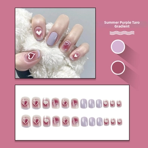 Detail view of purple gradient press-on nails set with white 3D heart decorations