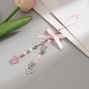 Close-up of pink ribbon bow phone charm with star and heart beads on metal chains
