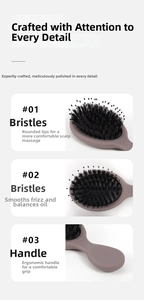 Detailed close-up of boar bristles and nylon pins on a pink massage hairbrush