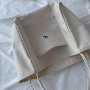 Detailed texture of cream canvas tote bag with a minimalist black percent symbol print