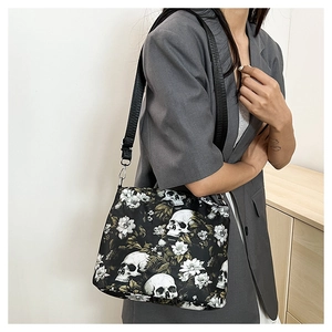 Gothic floral skull shoulder bag with vintage jacquard print shown on a female model