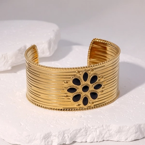 Polished 18k gold plated stainless steel open bangle with black floral sun motif inlay