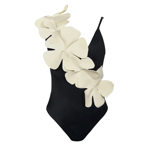 Detailed view of 3D white floral applique on a slim black one-piece swimsuit