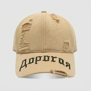 Detailed macro view of distressed cotton fabric and embroidery on kids' hip-hop cap