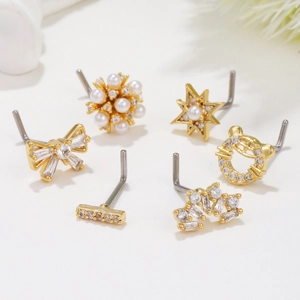 Set of 6 gold nose studs featuring bow, star, and pearl designs with cubic zirconia