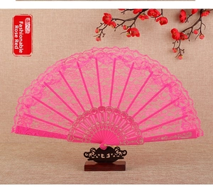 Detail of rose red lace folding fan with floral embroidery and gold stamped patterns