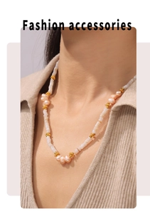Detail of baroque pearl and shell beaded necklace with 18k gold-plated flower spacers