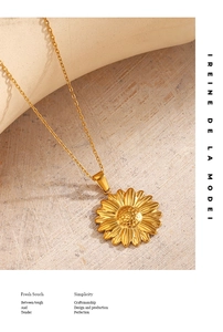 Detailed view of an 18K gold plated sunflower pendant on a stainless steel chain
