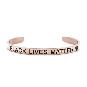 Macro detail of rose gold stainless steel bracelet with Black Lives Matter engraving