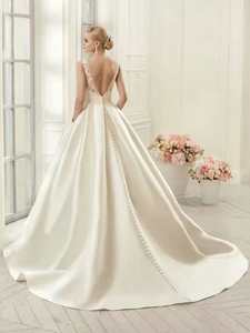 Detail of elegant backless wedding dress with lace lace trim and long train