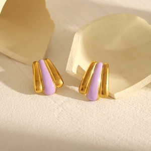 Macro shot of 18k gold plated fan-shaped earrings with purple enamel detailing
