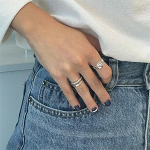 Close-up of minimalist 925 silver rings on hand with polished wide and double band designs