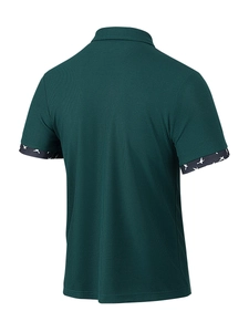Detail of dark green waffle knit polo shirt showing bird pattern cuff and fabric texture