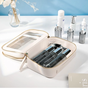 Detail view of double-zippered beige makeup bag with transparent window and interior storage