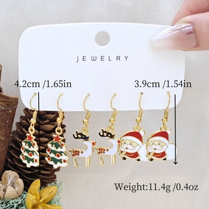 Detailed view of Christmas earring set with snowman and reindeer on a white card display