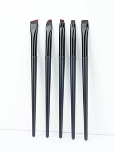 Macro shot of 5 precision eye makeup brushes with angled and flat synthetic bristles
