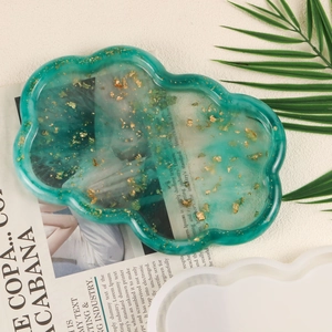 Macro view of forest green resin cloud tray with gold foil and its silicone mold