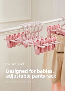 Adjustable pink children's clothes hanger with bow detail showing telescopic width feature