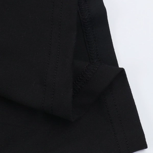Detail of double-needle stitching and overlock edge on black knitted lace jumpsuit
