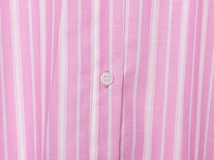 Detailed close-up of pink and white striped shirt fabric with white four-hole buttons