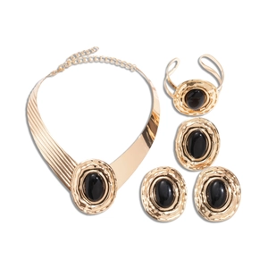 Golden chunky jewelry set with black oval pendants featuring necklace and earrings