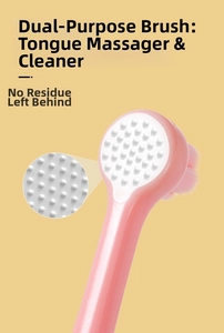 Detailed view of dual-sided pink toothbrush head with soft bristles and silicone massage pad