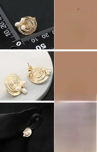 Detail of 18K gold plated spiral disc earrings featuring three natural white pearls