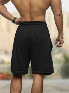 Rear view of black lightweight summer shorts with elastic waistband and casual loose fit