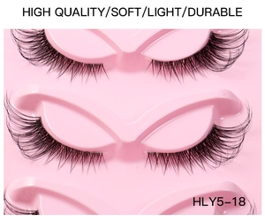 Detail shot of five pairs of winged cat-eye false eyelashes in a pink display tray
