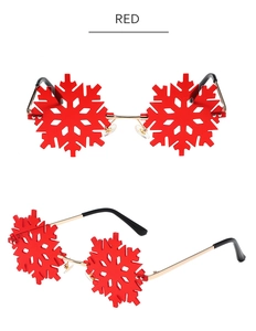 Detail view of red snowflake rimless sunglasses with gold metal temples and red lenses