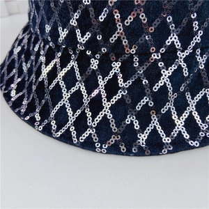 Close-up of black bucket hat featuring silver sequin diamond patterns and fine embroidery