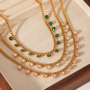Gold Cuban chain necklaces with round green, clear, and pink crystals in a luxury wooden box
