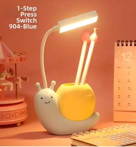 Detail of cartoon snail desk lamp showing blue pencil holder and adjustable light neck