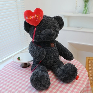 Detail of dark grey curly teddy bear holding a red heart balloon with embroidery