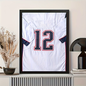 Detail of white mini sports jersey with number 12 in a black magnetic display frame